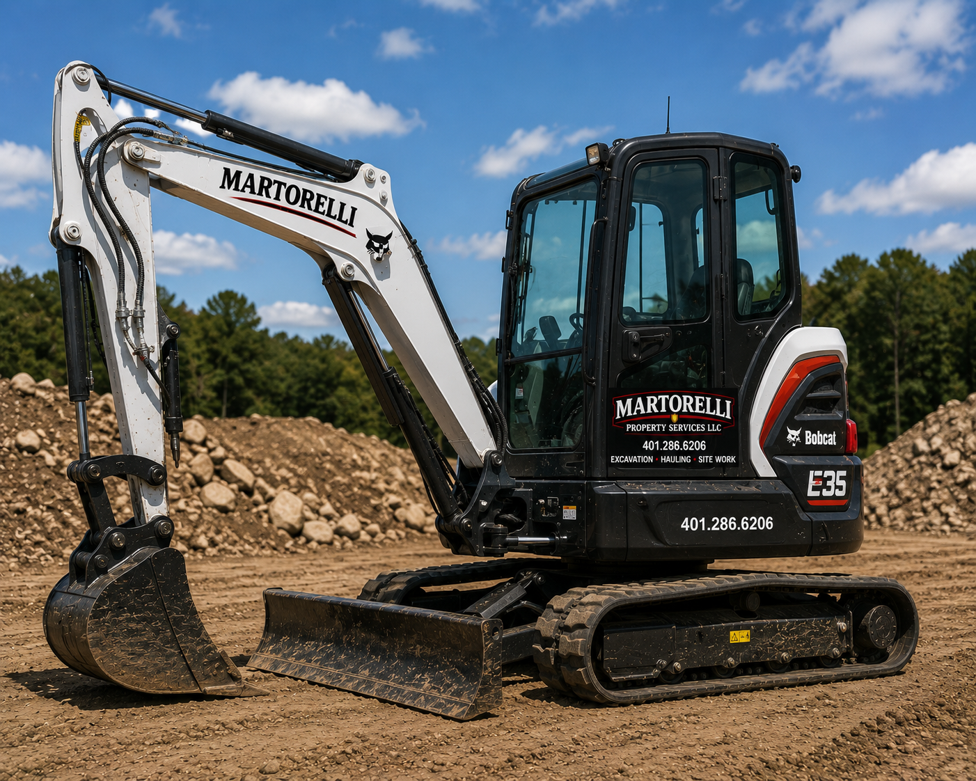 Martorelli Property Services branded Bobcat E35 mini-excavator on a Rhode Island excavation and site work job